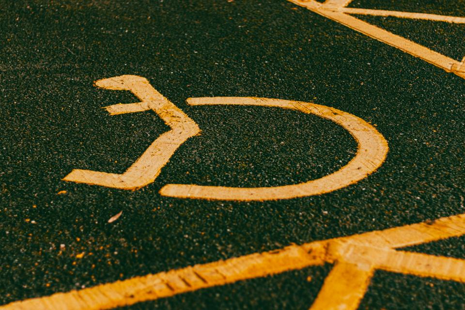 A faded parking space with accessibility symbol